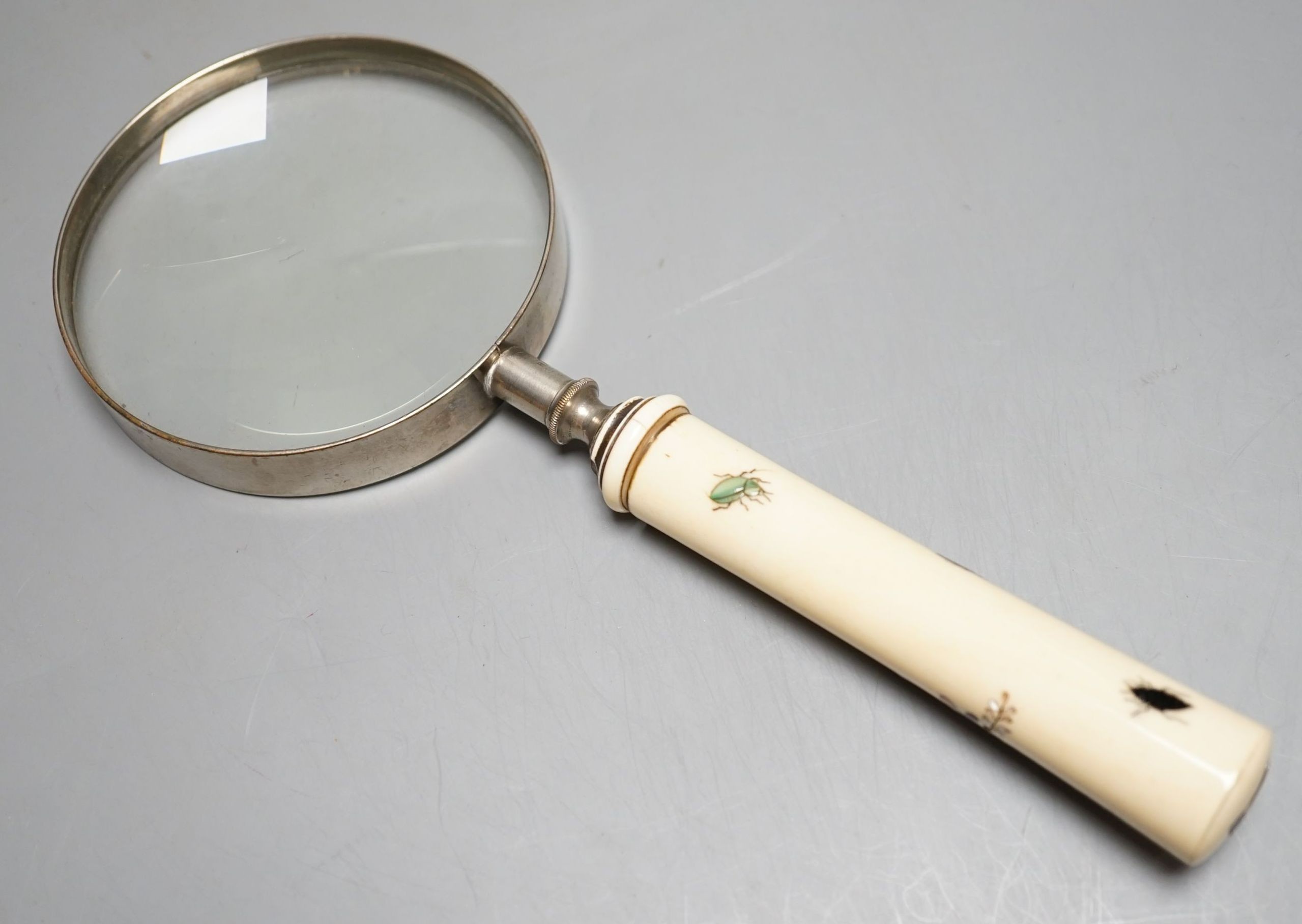 A Japanese Shibayama ivory and bone inlay handled magnifying glass decorated with insects and blossom, handle 11 cms long.